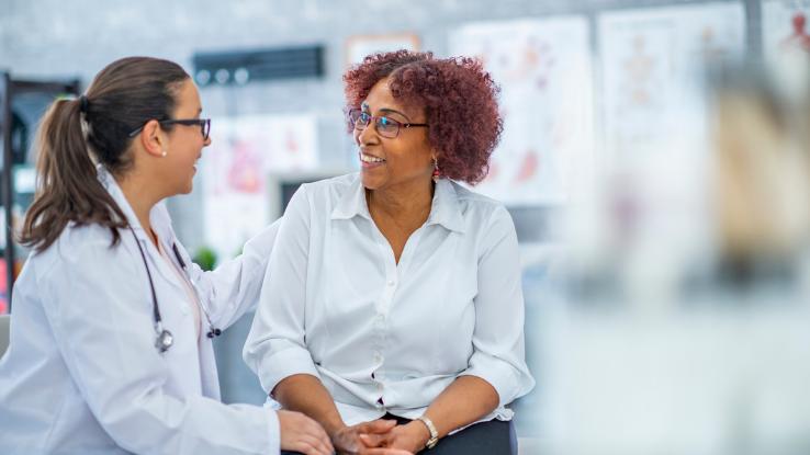 A woman talks with her doctor about diabetes.